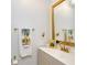 Well-lit bathroom featuring a white vanity with modern faucet, gold framed mirror and colorful accents at 1575 Belfast Ct, Apopka, FL 32712