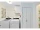 Convenient laundry room featuring modern washer and dryer units at 1575 Belfast Ct, Apopka, FL 32712