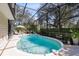 Inviting kidney-shaped pool with a screened enclosure, offering a private outdoor retreat at 1575 Belfast Ct, Apopka, FL 32712