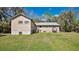 View of the back of a house with an expansive backyard, showcasing lawn and exterior features at 16318 Hamilton Dr, Orlando, FL 32833