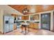 Well-lit kitchen with wood cabinets, stainless steel appliances, and wood floors at 16318 Hamilton Dr, Orlando, FL 32833