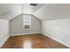 Bright attic bedroom with hardwood floors, a window, and neutral walls, offering a versatile space at 1975 Staunton Ave, Winter Park, FL 32789