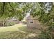 Spacious backyard featuring a wood fence, lush greenery, and partial views of the house at 1975 Staunton Ave, Winter Park, FL 32789