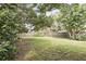 A sprawling backyard with plenty of green space, enclosed by a wooden fence at 1975 Staunton Ave, Winter Park, FL 32789