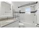 Clean bathroom featuring a granite-topped vanity, white subway tile, and a shower-tub combo with a black shower curtain rod at 1975 Staunton Ave, Winter Park, FL 32789