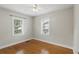 Clean bedroom featuring hardwood floors and bright, natural light from the windows at 1975 Staunton Ave, Winter Park, FL 32789