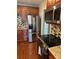 Well-equipped kitchen featuring stainless steel appliances, wooden cabinets, and stylish backsplash at 1975 Staunton Ave, Winter Park, FL 32789