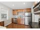 Modern kitchen featuring stainless steel appliances, granite countertops and ample cabinet space at 1975 Staunton Ave, Winter Park, FL 32789