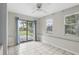 Bright room with tile floors, a sliding glass door to the backyard, and a window with blinds at 1975 Staunton Ave, Winter Park, FL 32789