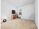 Cozy bedroom featuring beige carpet, a window, and a storage unit at 2056 Switch Grass Cir, Ocoee, FL 34761