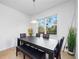 Cozy dining area with natural light, table, bench seating, and view to the yard at 2056 Switch Grass Cir, Ocoee, FL 34761