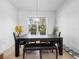 Dining area with table, bench seating, modern light fixture, and a view to the yard at 2056 Switch Grass Cir, Ocoee, FL 34761