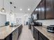 Modern kitchen featuring granite counters, stainless appliances, and pendant lighting at 2056 Switch Grass Cir, Ocoee, FL 34761