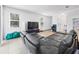 Bright living room featuring tile floors, a large TV, and sliding glass door access to outdoors at 2056 Switch Grass Cir, Ocoee, FL 34761