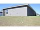 View of the backyard showing the screen porch and partially fenced back lawn at 2294 Sunset Way, Davenport, FL 33837