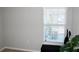 Light filled bedroom features a window, black storage bench, and modern vacuum at 2294 Sunset Way, Davenport, FL 33837