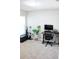 Neutral bedroom includes a black desk, chair, and a large window for natural light at 2294 Sunset Way, Davenport, FL 33837