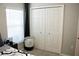 This bedroom features a large closet, a window and nice light gray walls at 2294 Sunset Way, Davenport, FL 33837