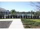 A beautifully landscaped walkway leads to the community pool area, partially visible through lush green hedges at 2294 Sunset Way, Davenport, FL 33837