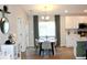 Open concept dining area featuring a modern light fixture and hardwood flooring at 2294 Sunset Way, Davenport, FL 33837