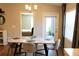 Dining table featuring modern light fixture, chairs and a large sliding door at 2294 Sunset Way, Davenport, FL 33837