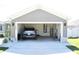 View of the garage, featuring a car, storage, and access to utilities at 2294 Sunset Way, Davenport, FL 33837