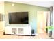 A bright living room with a TV, console, and a plant near the window at 2294 Sunset Way, Davenport, FL 33837