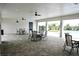 Covered patio featuring ceiling fans, tables, and chairs with views of the community pool and landscaping at 2294 Sunset Way, Davenport, FL 33837