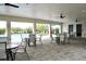 Covered patio featuring ceiling fans, tables, and chairs with views of the community pool and landscaping at 2294 Sunset Way, Davenport, FL 33837