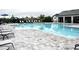 Community pool featuring a pool house, lounge chairs, and clear blue water at 2294 Sunset Way, Davenport, FL 33837