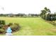 Spacious green lawn with decorative bushes and a fire hydrant at 2294 Sunset Way, Davenport, FL 33837