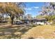 View of the home's backyard featuring plenty of green space at 2303 Mahoney Ave, Leesburg, FL 34748