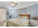 This bedroom features a ceiling fan, crown molding, and wood-look floors at 2303 Mahoney Ave, Leesburg, FL 34748