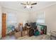 This bedroom features wood-look floors and a window with blinds at 2303 Mahoney Ave, Leesburg, FL 34748