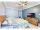 This bedroom features a ceiling fan, crown molding, and wood-look floors at 2303 Mahoney Ave, Leesburg, FL 34748