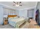 This bedroom features a ceiling fan, crown molding, and wood-look floors at 2303 Mahoney Ave, Leesburg, FL 34748