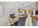 Cozy dining area with classic chandelier, adjacent to a kitchen space, and decorated with fresh flowers on the table at 2303 Mahoney Ave, Leesburg, FL 34748