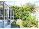 A view of the backyard of the home featuring tropical landscaping at 2511 Crown Ridge Cir, Kissimmee, FL 34744