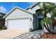 View of home with garage, landscaped walkway and yard at 2511 Crown Ridge Cir, Kissimmee, FL 34744