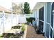 Exterior shot of side yard with white fence and rock garden at 2511 Crown Ridge Cir, Kissimmee, FL 34744