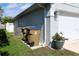 Exterior view of the home with garbage cans and landscaping at 2511 Crown Ridge Cir, Kissimmee, FL 34744