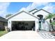 View of home with garage open showing interior items at 2511 Crown Ridge Cir, Kissimmee, FL 34744