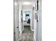 Hallway with modern wood-look flooring, updated lighting, and seamless transition to bedrooms at 2511 Crown Ridge Cir, Kissimmee, FL 34744