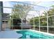 Inviting screened-in pool surrounded by tropical landscaping, perfect for relaxing and enjoying the outdoors at 2511 Crown Ridge Cir, Kissimmee, FL 34744