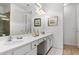 Bathroom showcasing a double vanity with white countertops and decorative light fixtures at 2626 Calistoga Ave, Kissimmee, FL 34741