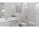 Well-lit bathroom with a shower-tub combo, single vanity, and modern fixtures at 2626 Calistoga Ave, Kissimmee, FL 34741