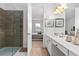 Bathroom with glass shower enclosure, wood-look tile flooring, vanity, and bedroom view at 2626 Calistoga Ave, Kissimmee, FL 34741