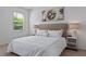 Serene bedroom with a king-size bed, tufted headboard, and soft, natural light from the window at 2626 Calistoga Ave, Kissimmee, FL 34741