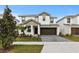 Charming two-story home with a well-manicured lawn, brown accents, and brick paver driveway at 2626 Calistoga Ave, Kissimmee, FL 34741