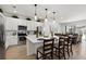 Modern white kitchen with stainless steel appliances, quartz countertops, and a large center island at 2626 Calistoga Ave, Kissimmee, FL 34741